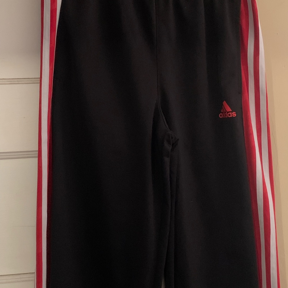 Black Adidas basketball pants with red and white stripes